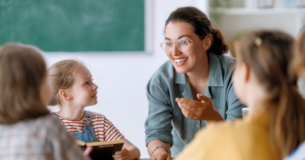 Teacher helping children