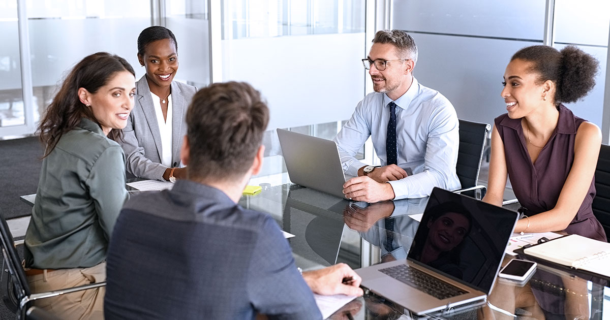 School leaders seated around a table in discussion