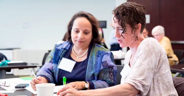 Photo of two adults in professional development setting